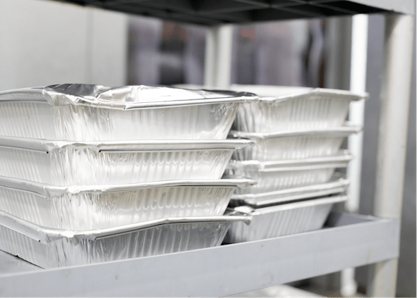 Shiny trays of pre-packaged rescued food
